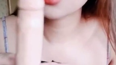 Hot asian Try to put condom using her mouth on her Strap-on